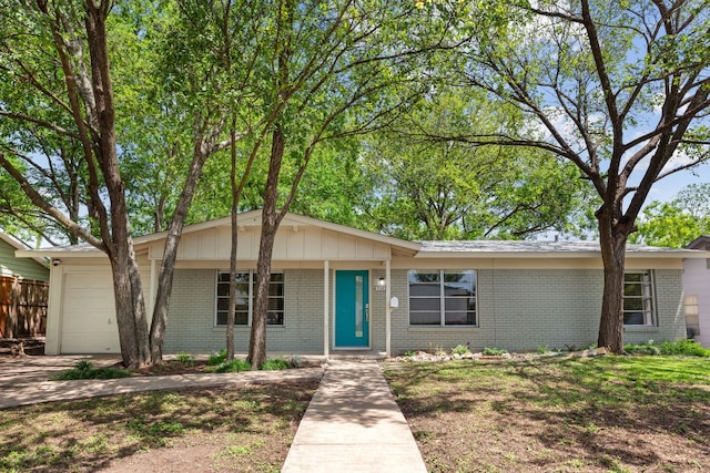5302 Robinsdale Ln, Austin, TX 78723 - ranch-style home featuring brick siding, a garage, and board and batten siding