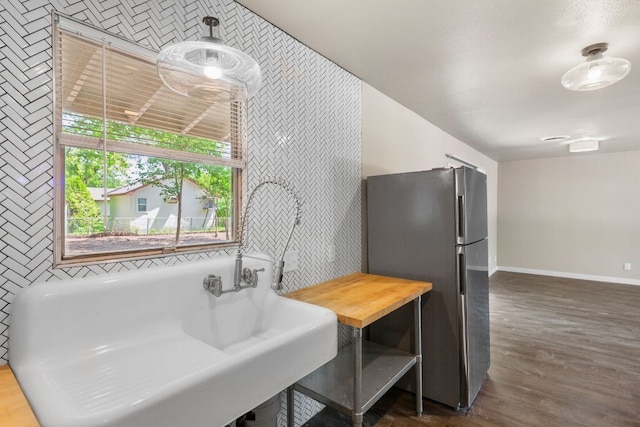 5302 Robinsdale Ln, Austin, TX 78723 - kitchen featuring freestanding refrigerator, butcher block countertops, and dark wood-style flooring