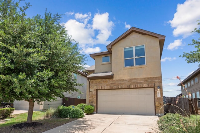 16216 Travesia Way, Austin, TX 78728 - view of front of house with a garage, driveway, stone siding, and stucco siding