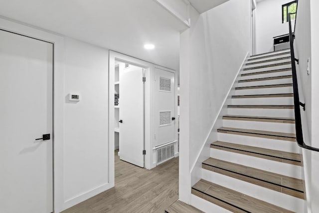 3520 Highland View Dr, Austin, TX 78731 - stairway with wood finished floors and recessed lighting