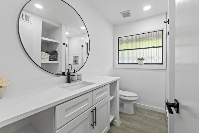 3520 Highland View Dr, Austin, TX 78731 - full bathroom featuring vanity, a stall shower, wood finished floors, and recessed lighting