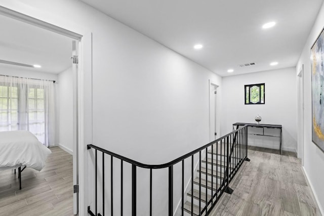 3520 Highland View Dr, Austin, TX 78731 - hall with wood finished floors, plenty of natural light, recessed lighting, and an upstairs landing