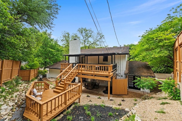 3520 Highland View Dr, Austin, TX 78731 - rear view of house featuring a wooden deck, stairs, a chimney, a shingled roof, and board and batten siding