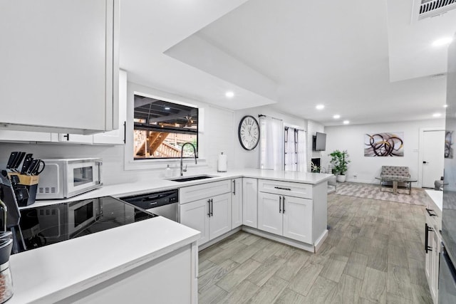 3520 Highland View Dr, Austin, TX 78731 - kitchen with dishwasher, a peninsula, recessed lighting, white microwave, and light countertops