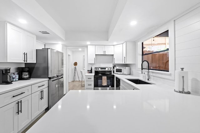 3520 Highland View Dr, Austin, TX 78731 - kitchen featuring stainless steel appliances, recessed lighting, light countertops, and white cabinetry