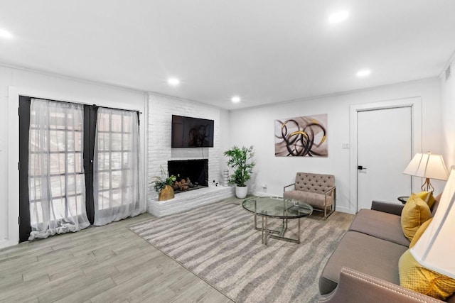3520 Highland View Dr, Austin, TX 78731 - living room with wood finished floors, recessed lighting, and a brick fireplace