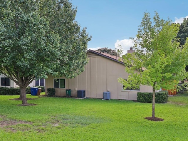 11608 Norwegian Wood Dr, Austin, TX 78758 - view of side of home featuring a lawn and a chimney