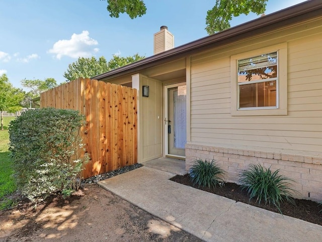 11608 Norwegian Wood Dr, Austin, TX 78758 - view of exterior entry featuring a chimney