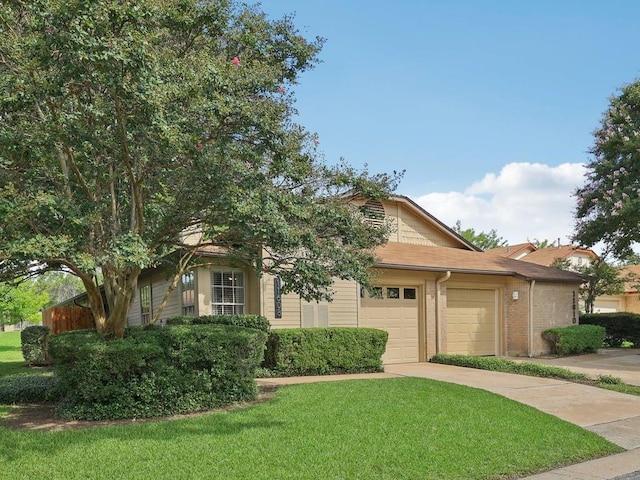 11608 Norwegian Wood Dr, Austin, TX 78758 - view of front of house with an attached garage, a front lawn, driveway, and brick siding