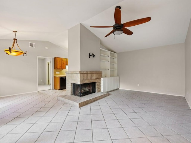 11608 Norwegian Wood Dr, Austin, TX 78758 - unfurnished living room with lofted ceiling, ceiling fan, light tile patterned flooring, a brick fireplace, and built in shelves