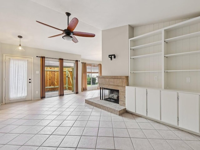 11608 Norwegian Wood Dr, Austin, TX 78758 - unfurnished living room with light tile patterned flooring, ceiling fan, and a fireplace