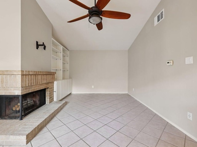 11608 Norwegian Wood Dr, Austin, TX 78758 - unfurnished living room with ceiling fan, a brick fireplace, tile patterned floors, built in features, and vaulted ceiling