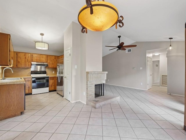 11608 Norwegian Wood Dr, Austin, TX 78758 - kitchen featuring electric range, stainless steel fridge, light countertops, under cabinet range hood, and light tile patterned floors