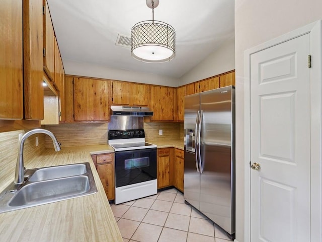 11608 Norwegian Wood Dr, Austin, TX 78758 - kitchen with stainless steel fridge with ice dispenser, under cabinet range hood, range with electric cooktop, brown cabinetry, and light countertops