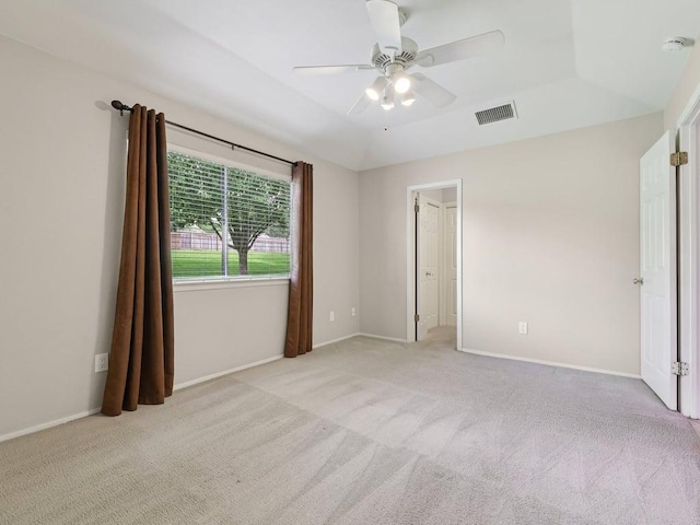 11608 Norwegian Wood Dr, Austin, TX 78758 - unfurnished bedroom featuring light carpet, ceiling fan, and a raised ceiling