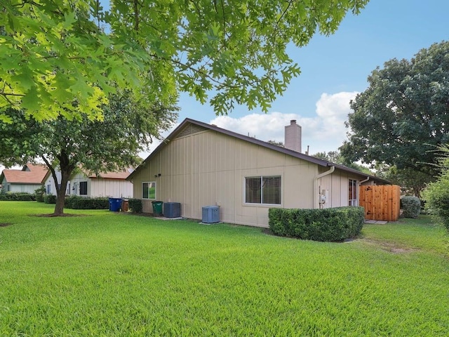 11608 Norwegian Wood Dr, Austin, TX 78758 - view of property exterior with a chimney and a yard