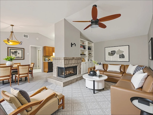 11608 Norwegian Wood Dr, Austin, TX 78758 - living room with vaulted ceiling, ceiling fan, a tiled fireplace, and built in shelves