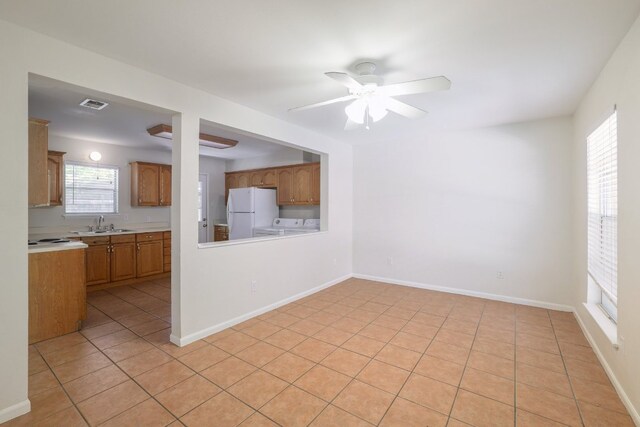 4108 Lewis Ln Unit A & B, Austin, TX 78756 - unfurnished living room with ceiling fan, light tile patterned floors, and washer and clothes dryer