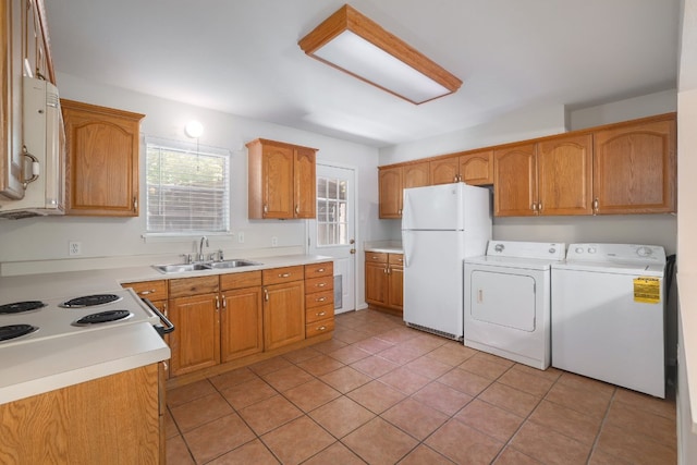 4108 Lewis Ln Unit A & B, Austin, TX 78756 - kitchen with white appliances, washer and dryer, light tile patterned floors, light countertops, and brown cabinetry