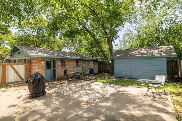 4108 Lewis Ln Unit A & B, Austin, TX 78756 - back of property with a patio area, brick siding, and a storage shed