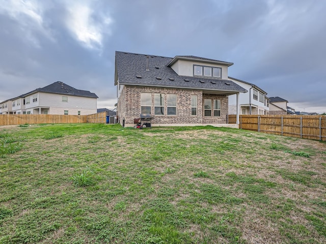 2800 Sebring Cir, Austin, TX 78747 - rear view of property with a fenced backyard, brick siding, and a shingled roof