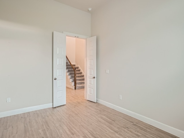 2800 Sebring Cir, Austin, TX 78747 - unfurnished room featuring light wood finished floors, stairway, and a smoke detector