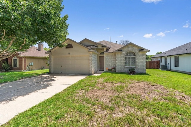 208 Meadowside Dr, Hutto, TX 78634 - ranch-style home with brick siding, a garage, and concrete driveway