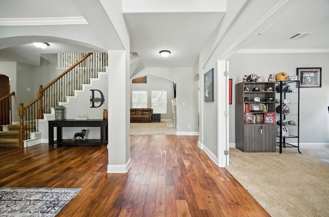1208 Pine Forest Cir, Round Rock, TX 78665 - foyer featuring arched walkways, stairway, wood-type flooring, and crown molding