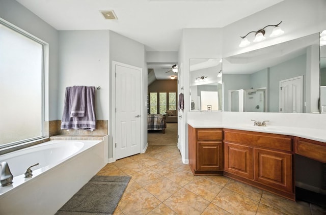 1208 Pine Forest Cir, Round Rock, TX 78665 - ensuite bathroom with a ceiling fan, a garden tub, a stall shower, vanity, and vaulted ceiling