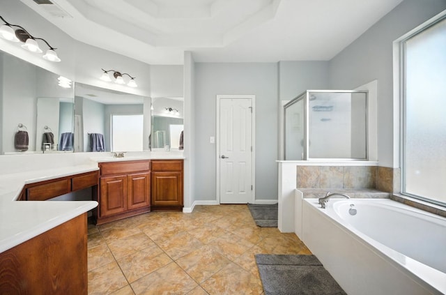 1208 Pine Forest Cir, Round Rock, TX 78665 - bathroom with a shower stall, vanity, a bath, and a tray ceiling