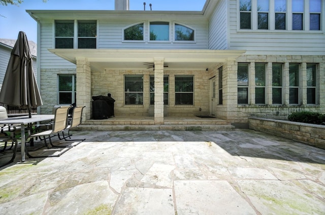 1208 Pine Forest Cir, Round Rock, TX 78665 - rear view of property with a patio, stone siding, and outdoor dining space