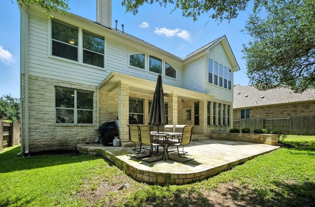 1208 Pine Forest Cir, Round Rock, TX 78665 - back of property featuring stone siding and a patio area