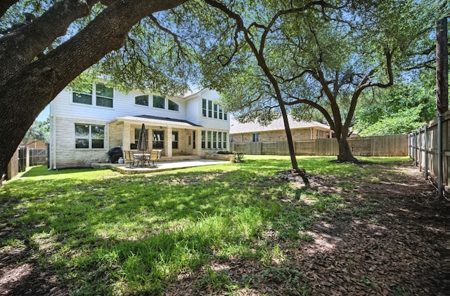 1208 Pine Forest Cir, Round Rock, TX 78665 - back of house with a patio, a fenced backyard, and stone siding