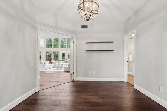 7204 Guava Cv, Austin, TX 78750 - spare room featuring a chandelier and dark wood-type flooring