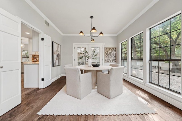 7204 Guava Cv, Austin, TX 78750 - unfurnished dining area with plenty of natural light, crown molding, dark wood-style floors, and a chandelier