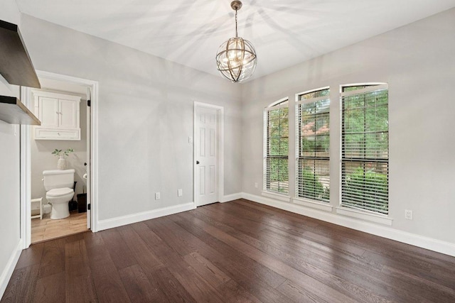 7204 Guava Cv, Austin, TX 78750 - spare room with a chandelier and dark wood-type flooring