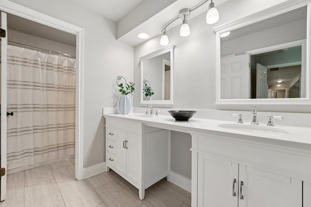7204 Guava Cv, Austin, TX 78750 - full bathroom with double vanity and baseboards