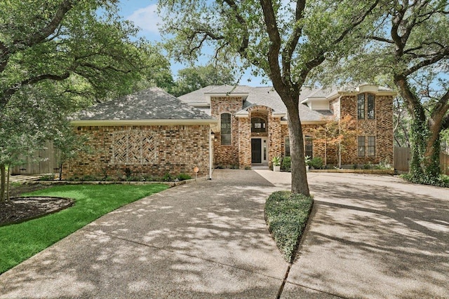 7204 Guava Cv, Austin, TX 78750 - view of front of house with brick siding, concrete driveway, and a shingled roof