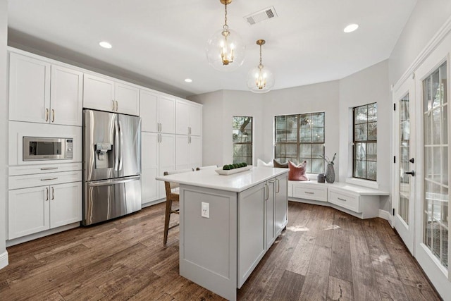 7204 Guava Cv, Austin, TX 78750 - kitchen featuring stainless steel appliances, dark wood-type flooring, pendant lighting, recessed lighting, and a center island