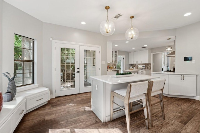 7204 Guava Cv, Austin, TX 78750 - kitchen featuring french doors, white cabinets, dark wood-style floors, light countertops, and recessed lighting
