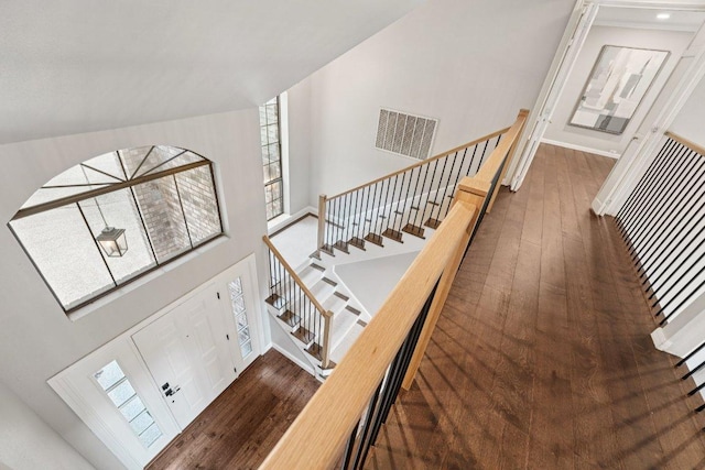 7204 Guava Cv, Austin, TX 78750 - stairway with wood-type flooring, healthy amount of natural light, and a high ceiling