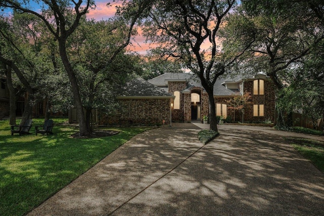 7204 Guava Cv, Austin, TX 78750 - view of front of home with driveway, a front lawn, and brick siding