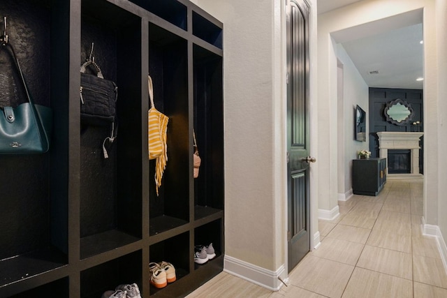 30872 Schlather Ln, Bulverde, TX 78163 - mudroom featuring a glass covered fireplace and tile patterned flooring