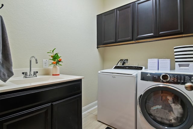 30872 Schlather Ln, Bulverde, TX 78163 - laundry area featuring cabinet space and independent washer and dryer