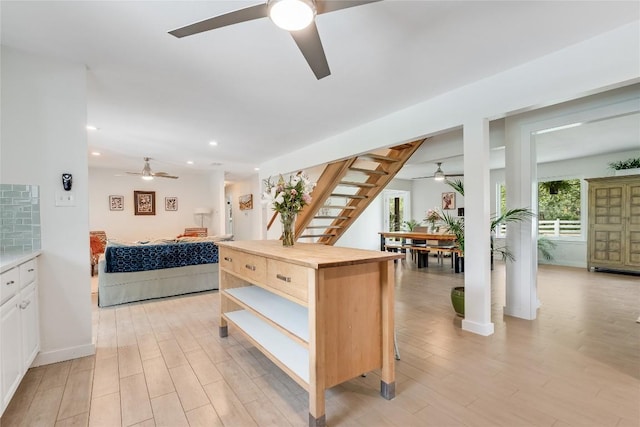 10133 Oliver Dr, Austin, TX 78737 - kitchen with ceiling fan, open floor plan, wood counters, light wood finished floors, and white cabinets