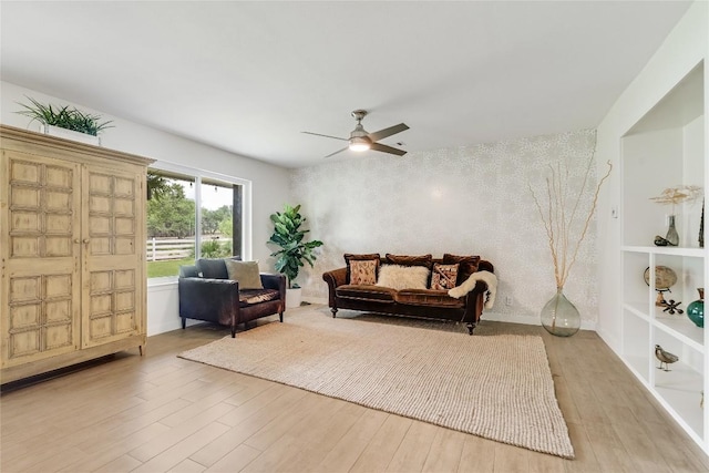 10133 Oliver Dr, Austin, TX 78737 - living room featuring light wood finished floors, ceiling fan, and an accent wall