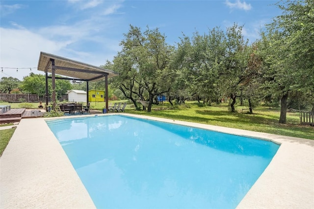 10133 Oliver Dr, Austin, TX 78737 - swimming pool with a wooden deck, an outbuilding, and view of scattered trees