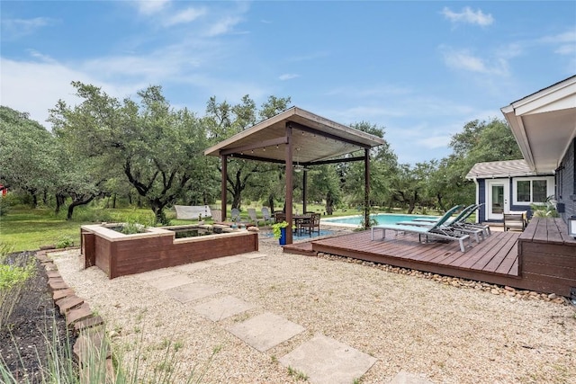 10133 Oliver Dr, Austin, TX 78737 - view of patio featuring a deck, an outdoor pool, and view of wooded area