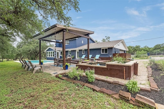 10133 Oliver Dr, Austin, TX 78737 - rear view of house with an outdoor pool, a lawn, brick siding, and a patio