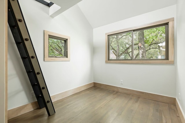 913 Christopher St, Austin, TX 78704 - spare room featuring wood finished floors and vaulted ceiling